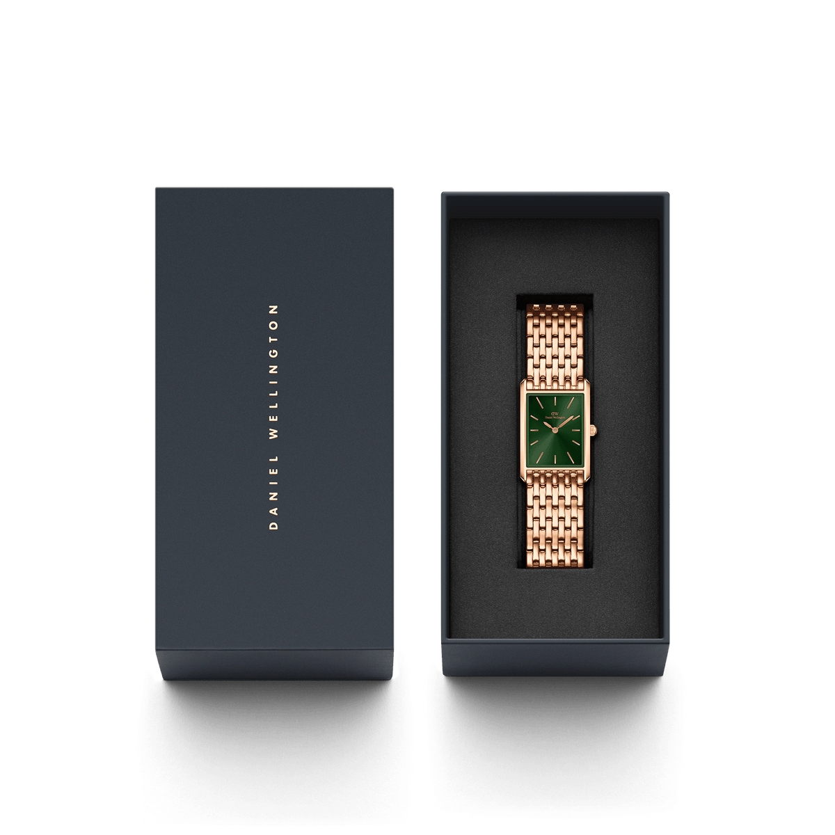 Daniel Wellingtonのネイビーのギフトボックスに収められたBound 9-Link Emerald Sunray。箔押しのブランドロゴが施された蓋と、黒いクッションの上にローズゴールドの9リンクブレスレットとエメラルドグリーンのダイヤルが映える本体が並んでいます。