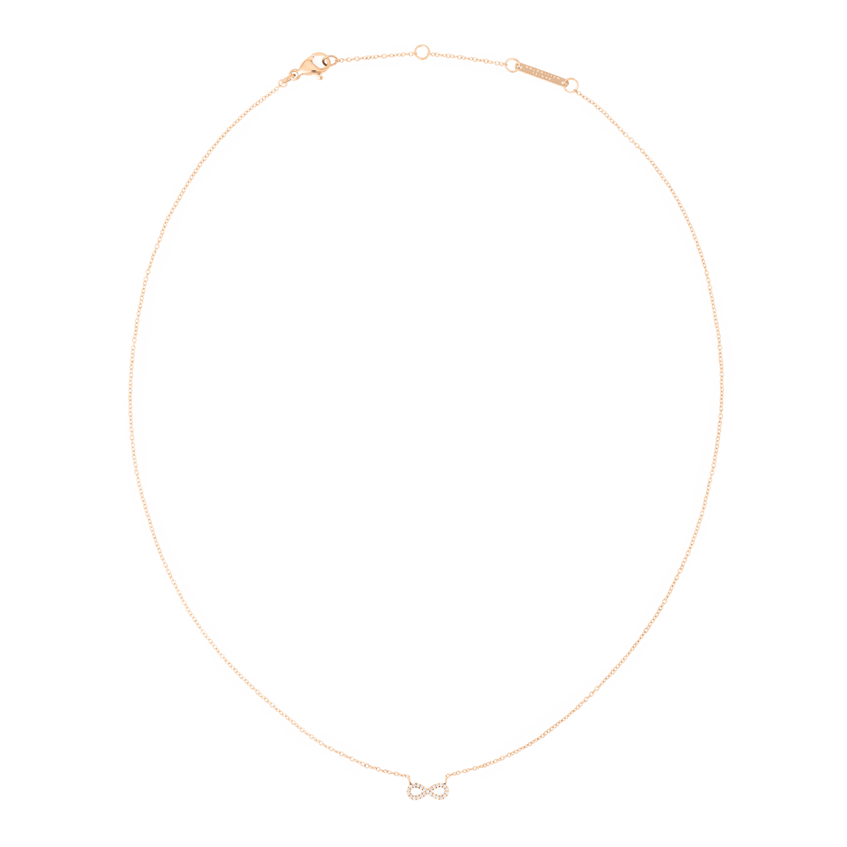 Daniel WellingtonのMirelle Infinity Necklaceを全体的にご覧いただけます。細身のローズゴールドチェーンの中央に、キュービックジルコニアをあしらったインフィニティモチーフが配されています。ロブスタークラスプと、ブランドロゴが刻印された延長チェーンも確認できます。