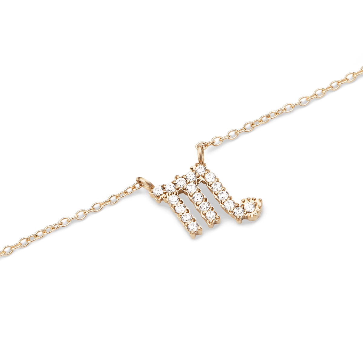 蠍座のシンボルをクリスタルで表現した**Crystal Zodiac Chain Necklace Gold**のペンダント部分を拡大した写真です。ゴールドの爪留めに一粒ずつセットされたクリスタルが光を反射し、繊細なゴールドチェーンとの美しい調和を見せています。