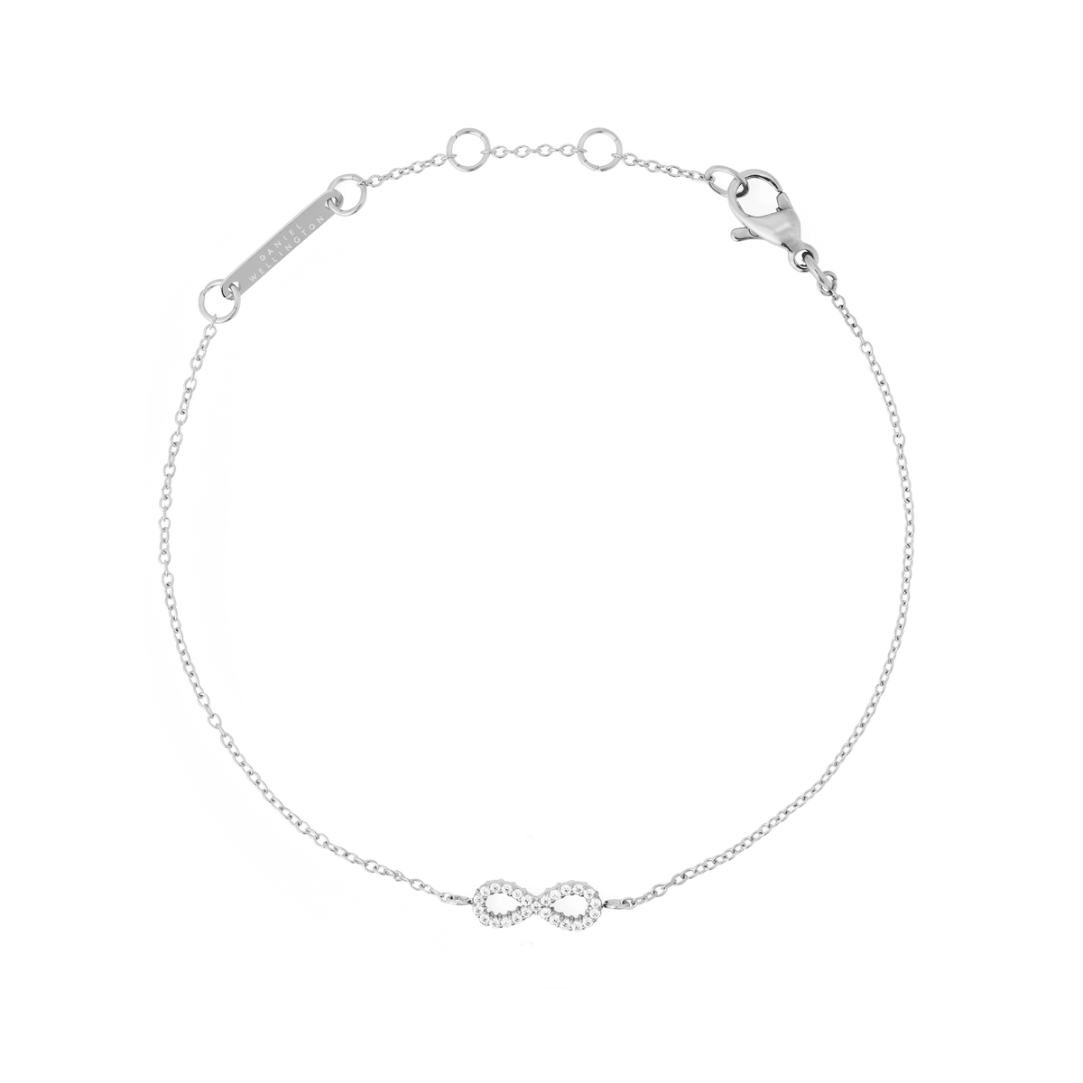 Daniel Wellington Mirelle Infinity Braceletのシルバー全体像です。細いチェーンの中央に、キュービックジルコニアをセットしたインフィニティモチーフがあしらわれており、ブランドロゴ入りのプレートとロブスタークラスプも確認できます。