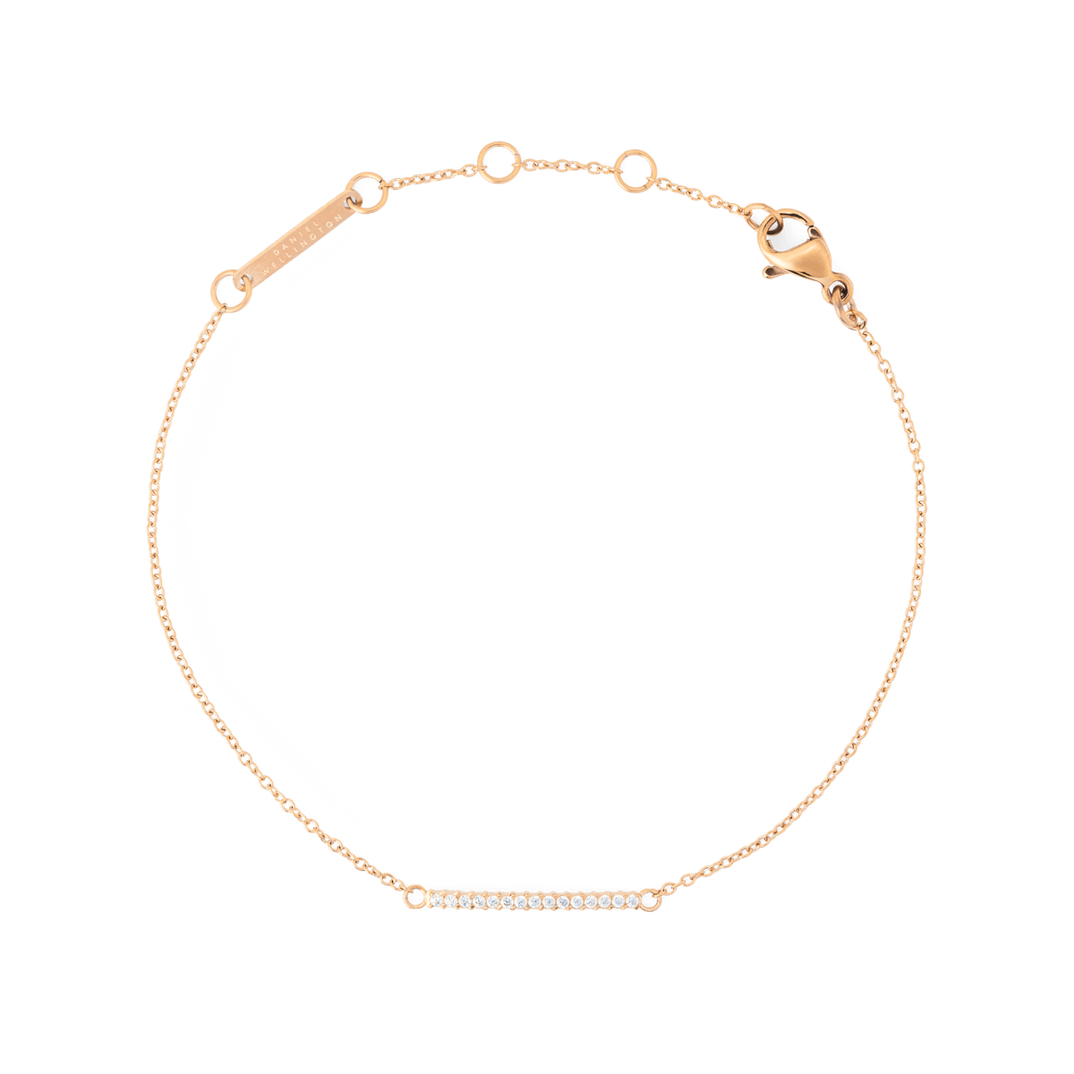Daniel Wellington Mirelle Eternity Bracelet Rose Goldの全体をご覧いただけます。細身のローズゴールドチェーンの中央には、ホワイトキュービックジルコニアを一列にあしらったバーのモチーフが配されています。ロブスタークラスプとアジャスターリングも確認できます。