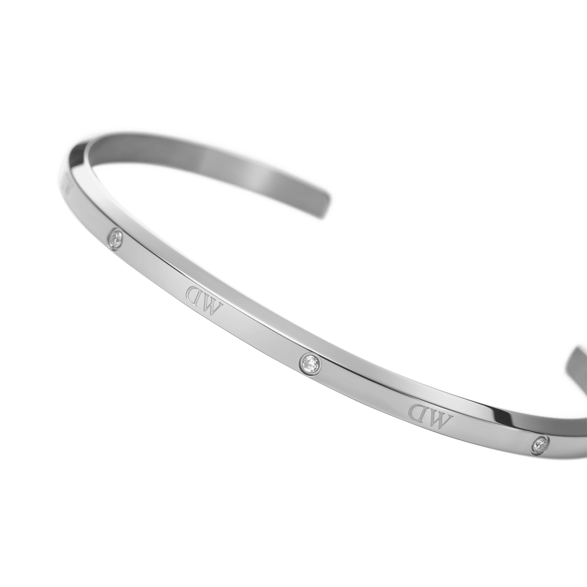 Classic Lumine Bracelet Sのクローズアップ画像です。鏡面仕上げのシルバーカラーを採用したオープンカフには、小粒のクリスタルとブランドロゴが等間隔に配置され、細部までこだわったデザインが際立ちます。