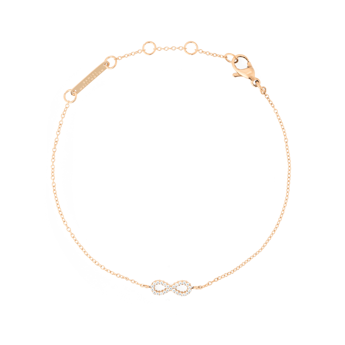 Daniel Wellington Mirelle Infinity Braceletの全体を捉えた画像です。ローズゴールドの細いチェーンの中央に、クリスタルをあしらったインフィニティモチーフが配されています。ロブスタークラスプとブランドプレートも確認できます。白背景で撮影された商品写真です。