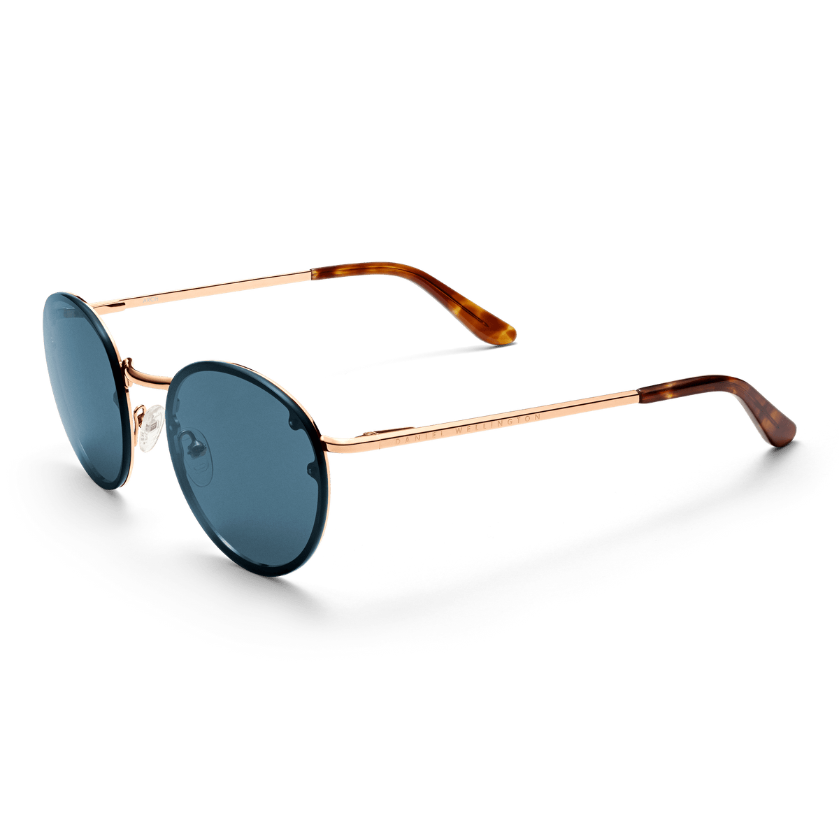 Arch Steel Blue Rose Goldを折りたたんだ状態で斜め上から撮影した画像です。ブルーレンズの丸みを帯びたシルエットと、ローズゴールドフレームの上品な光沢、べっ甲調テンプルエンドの質感が際立ちます。