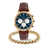 ダニエルウェリントン Iconic Chronograph Pandaのゴールドケースとブルーの文字盤にホワイトのサブダイヤルが映えるブラウンレザーストラップモデルと、ゴールドのEllipse Cuban Chain Braceletをセットにしたギフトアイテムです。