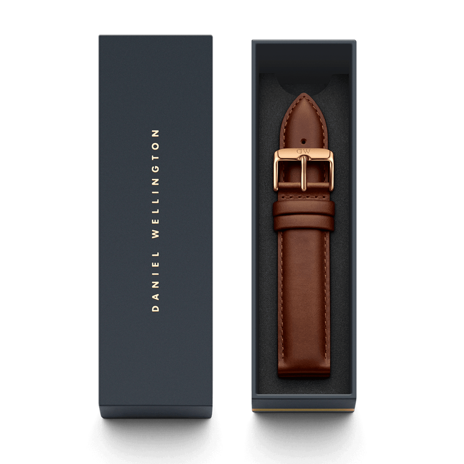 St Mawes XL ローズゴールドにブラウンレザーストラップを組み合わせ、ダークネイビーの専用ボックスに収めた状態です。ボックスの蓋にはDaniel Wellingtonのロゴがゴールドであしらわれており、ギフトにも最適な上品なパッケージとなっています。