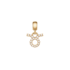 おうし座のCrystal Zodiac Charm Gold。円形と上部に広がる2本の角をあしらったタウラスのシンボルには、キュービックジルコニアが丁寧にセットされています。ゴールドのベイルとともに、白い背景で撮影した一枚です。