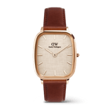 Daniel WellingtonのMarlon St Mawes Linen Rose Goldです。丸みを帯びたクッション型のローズゴールドケースに、リネンのエンボス加工を施したダイヤル、ブラウンのレザーストラップを組み合わせたメンズ腕時計です。