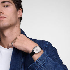 デニムジャケットに白Tシャツを合わせた男性が、Marlon Sheffield Linen Silverを着用したスタイル。クッション型のシルバーケースとブラックレザーストラップが、カジュアルなコーディネートに自然に馴染んでいます。