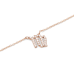 クリスタルZodiac Chain Necklace Rose Goldのおとめ座ペンダントを拡大した写真です。ローズゴールドの繊細なチェーンに、クリスタルをあしらったおとめ座のシンボルが、光を受けて美しく輝いています。