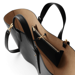 River Bag Blackの内部を上から見たディテール画像です。ベージュのスエード調ライニングと、ゴールドファスナー付きの内ポケットが確認できます。ブラックレザーとの上品なカラーコントラストが際立っています。