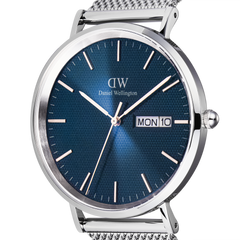 Classic Day Display Sterling Arcticの文字盤をクローズアップした画像です。ブルーの文字盤に広がる半透明のトライアングルパターンの質感や、シルバーのバーインデックス、3時位置に配されたデイデイト窓が鮮明に捉えられています。また、ポリッシュとブラッシュ仕上げが交差するケースの陰影も際立っています。
