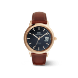 Iconic St Mawes Automatic Rose Goldの正面画像です。深みのあるブラックの文字盤に、ローズゴールドの夜光バーインデックスと針を配し、3時位置には日付表示の拡大窓を設けています。ブラウンのレザーストラップはステッチが施され、温かみのある質感に仕上げています。