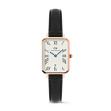 Daniel Wellington Quadro Roman Numerals Date Sheffieldの正面画像。ローズゴールドのレクタングルケースに、ローマ数字が配されたホワイトダイヤル、ブルーの針、6時位置の日付窓、ブラックレザーストラップを組み合わせたデザインです。