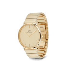 Daniel Wellington Classic Piano Link Gold Unitoneを斜め横から撮影した画像です。ゴールドで統一されたケースと文字盤、ピアノリンクブレスレットの一体感が際立ち、ブラッシュドとポリッシュの仕上げが交互に並ぶリンクの幾何学的な構造が確認できます。