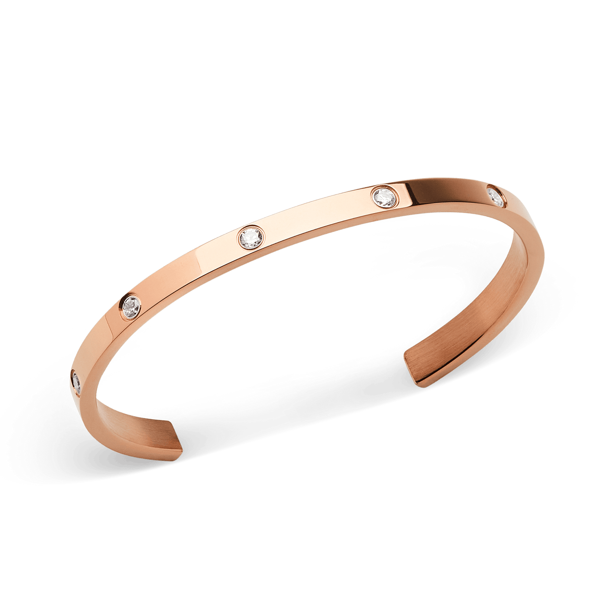 ローズゴールドのカフブレスレット「Classic Lumine Bracelet Rose Gold」を斜め上から撮影した写真です。ポリッシュ仕上げの美しい曲線と、表面にあしらわれたキュービックジルコニアの輝きが際立ちます。