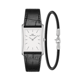 Daniel WellingtonのBoundレクタンギュラーウォッチとSheffield Braceletのギフトセットです。シルバーケースにホワイトダイヤル、ブラックのクロコダイル型押しレザーストラップをあしらった腕時計と、ブラックレザーにシルバークラスプのブレスレットをセットにしました。