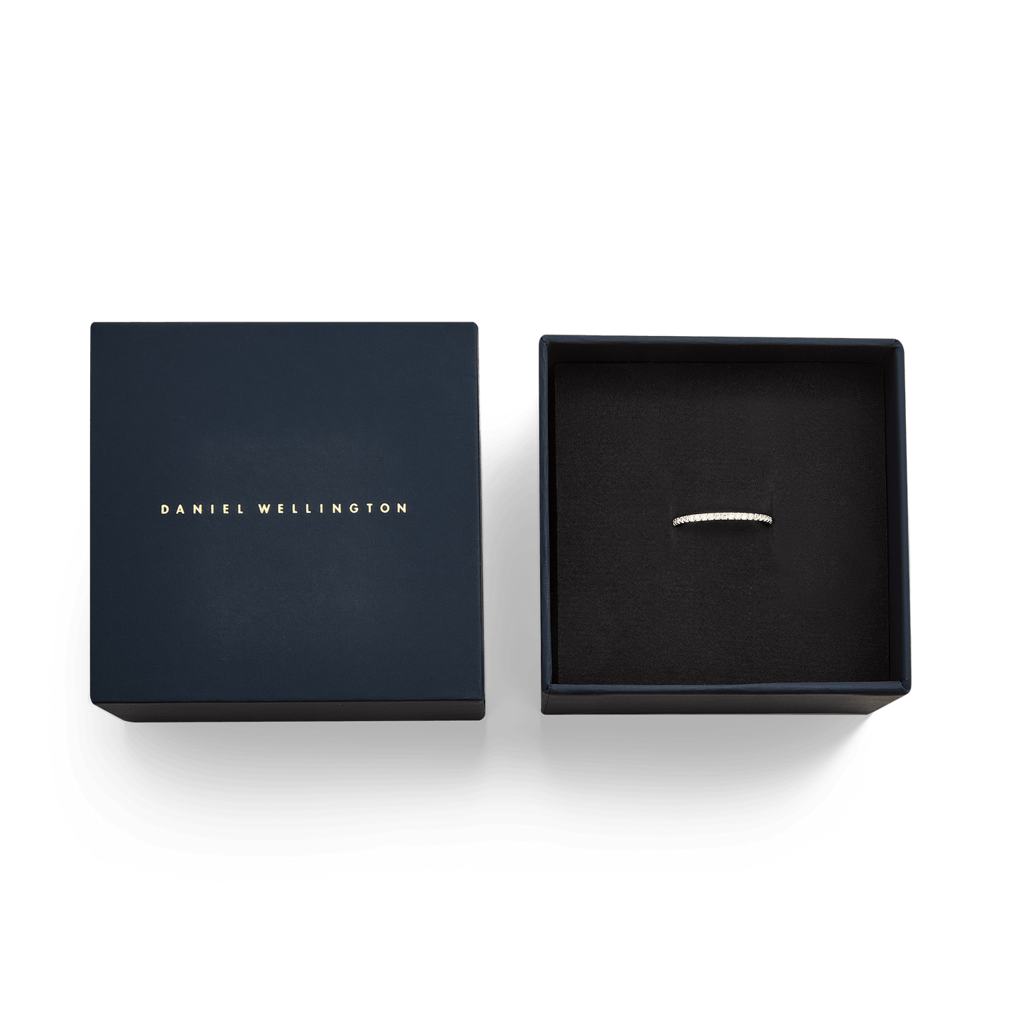 ダニエルウェリントンのダークネビーギフトボックスに収められたMirelle Eternity Ring Gold 1.4mm。箔押しのブランドロゴが施された蓋と、ブラッククッションの上に置かれた極細のエタニティリングがセットになっています。