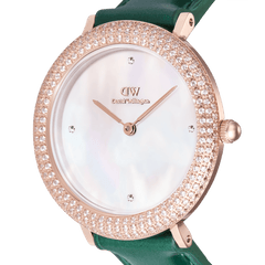 「Crystalline Bezel Green Croc Rose Gold」のダイヤル部分をクローズアップした商品画像です。ホワイトマザーオブパールのやわらかな輝き、12時・3時・6時・9時の位置にあしらわれたプレシオサストーン、ローズゴールドの針とロゴ、そしてベゼルに散りばめられたキュービックジルコニアの煌めきがお楽しみいただけます。