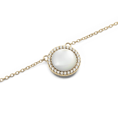 Audrey Necklace Mother of Pearl Goldのペンダント部分をクローズアップした写真です。ドーム型のマザーオブパールが柔らかな光を放ち、その周囲を囲むホワイトキュービックジルコニアのヘイローとゴールドフレームの細やかなディテールが際立ちます。