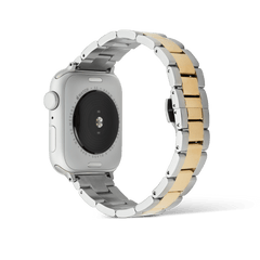 Daniel Wellington Smartwatch Iconic Linkツートンブレスレットを装着したApple Watch SEの背面画像。ケース裏面のセンサー部分とシルバー・ゴールドの3連リンクが輪を描くように配置されており、ブレスレット全体の厚みやリンクの連結構造が確認できます。