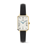 Daniel Wellington Quadro Roman Numerals Date Sheffieldの正面画像。ゴールドの長方形ケースに、ローマ数字とギョーシェ模様をあしらったホワイトダイヤル、ブルーの針、6時位置の日付窓を配し、ブラックレザーストラップを組み合わせたクラシックなデザインです。