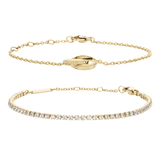 Daniel WellingtonのTennis BraceletとLumine Unity Braceletのゴールドセットです。一列に輝くクリスタルが特徴のテニスブレスレットと、交差する2つのリングをモチーフにした細身のチェーンブレスレットを、白い背景に並べて撮影した商品画像です。