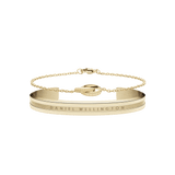 Daniel WellingtonのElan BraceletゴールドカフとElan Unity Braceletチェーンブレスレットを重ね付けしたセットです。ブラッシュ仕上げのカフにはブランドロゴが刻印され、交差するリングモチーフのチェーンが上品に調和しています。