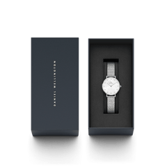 Daniel Wellingtonのギフトボックスに収められたPetite Lumine Pressed Piano White MoP Silver。ネイビーカラーのボックスにはブランドロゴが箔押しされ、白蝶貝の文字盤とシルバーのPianoストラップをあしらった腕時計が、黒いクッションケースの上に丁寧にセットされています。贈り物にぴったりのパッケージです。