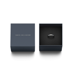 ダークネイビーの専用ギフトボックスに収められたClassic Lumine Ring Silver。ボックスの蓋にはDaniel Wellingtonのロゴが刻印され、黒いクッショニングの上にシルバーリングが丁寧にセットされています。贈り物にぴったりの上品なパッケージです。