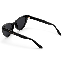 Lynx Bio-Acetate Blackを背面から捉えた画像です。テンプルの内側にはゴールドで刻印されたDaniel Wellingtonのロゴが、ヒンジ部分にはローズゴールドのアクセントが施されています。艶やかなブラックフレームの質感が際立ちます。