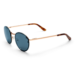 Arch Steel Blue Rose Goldを折りたたんだ状態で斜め上から撮影した画像です。ブルーレンズの丸みを帯びたシルエットと、ローズゴールドフレームの上品な光沢、べっ甲調テンプルエンドの質感が際立ちます。